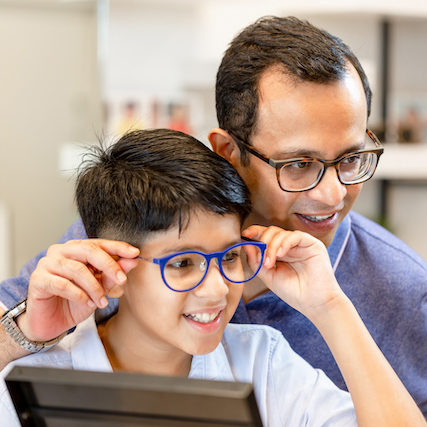 family in optometrist office wearing eyeglasses