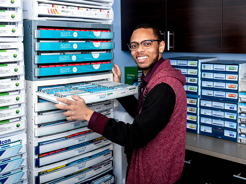 man taking out contact lenses from drawer